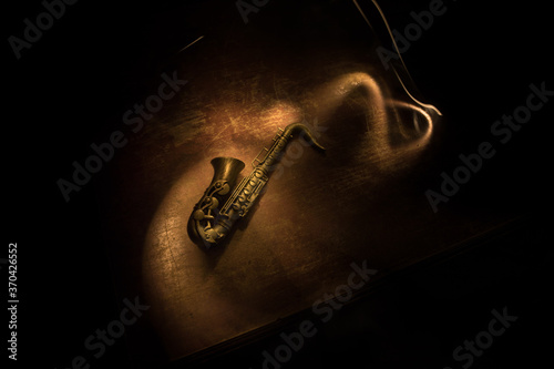 Canvas Print Alto gold sax miniature with colorful toned light on foggy background