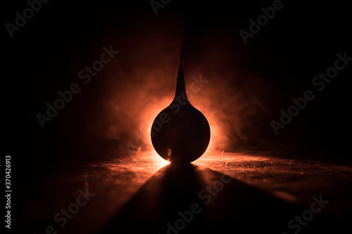 Blue enema on dark background with backlight. Creative artwork decorated with light. photo