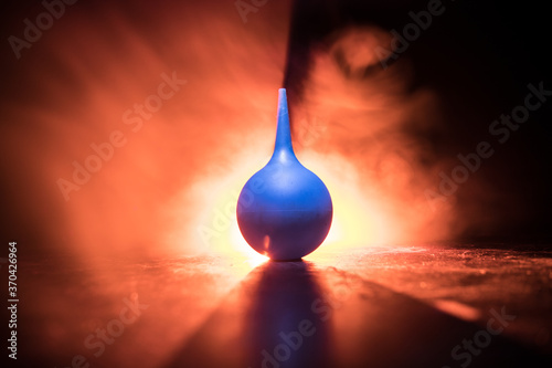 Canvas Print Blue enema on dark background with backlight