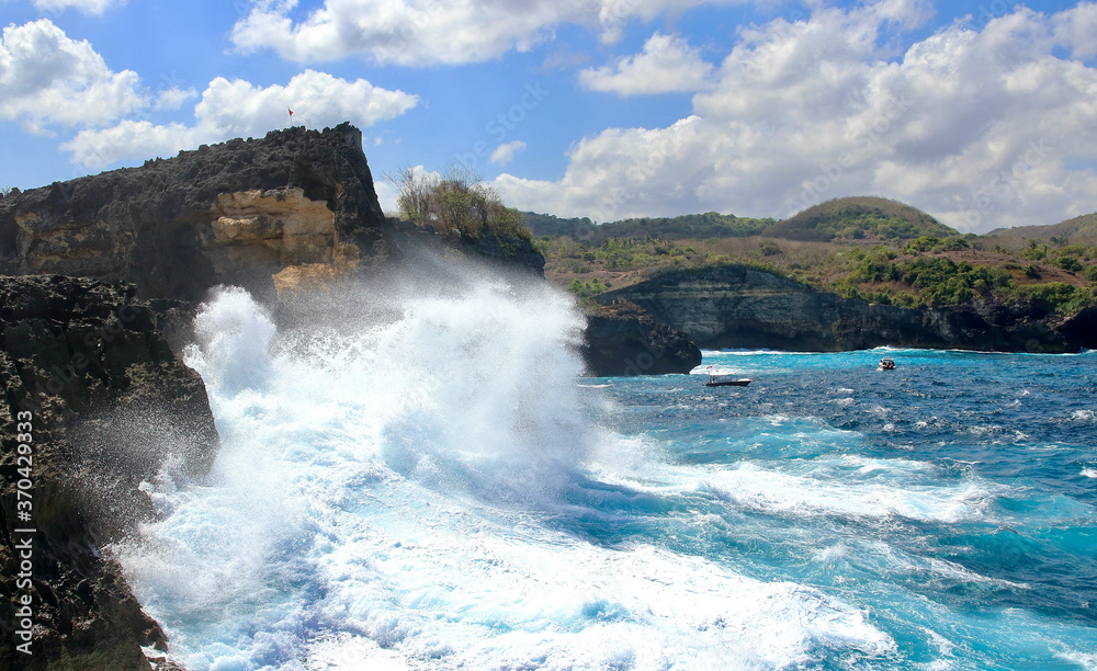 Indic sea waves hitting the cliff rocks at Angel’s Billabong point, an amazing spot close to Broken beach in Nusa Penida Island, Indonesia.