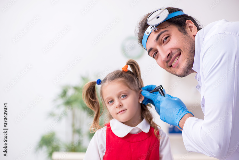 Small girl visiting young male doctor otorhinolaryngologist Small girl visiting young male doctor otorhinolaryngologist