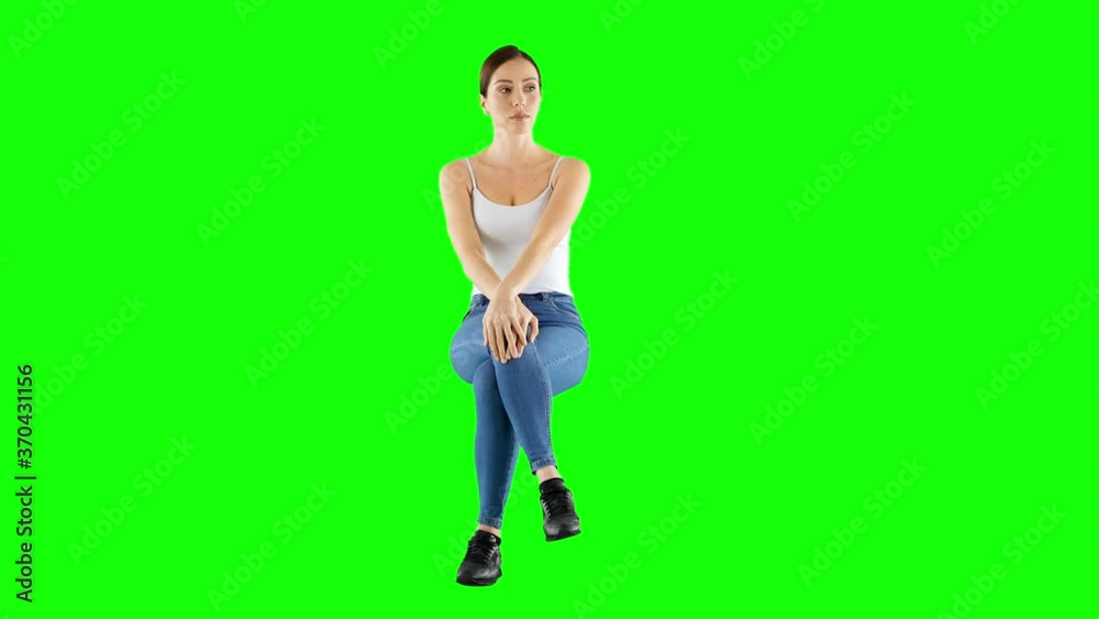 Worried Woman Wearing Tank Top And Jeans Sitting and Waiting Green Screen Worried Woman Wearing Tank Top And Jeans Sitting and Waiting Green Screen