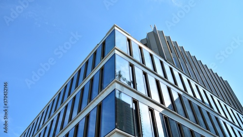 Panoramic and perspective wide angle view to steel blue background of glass. Business concept of successful office architecture.Office building with glass wall. 