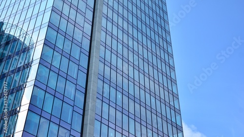 Bottom view of glass silhouette of skyscraper. Business building. Skyscraper with glass facade. Modern building in business district. Concepts of economics  financial  future.   