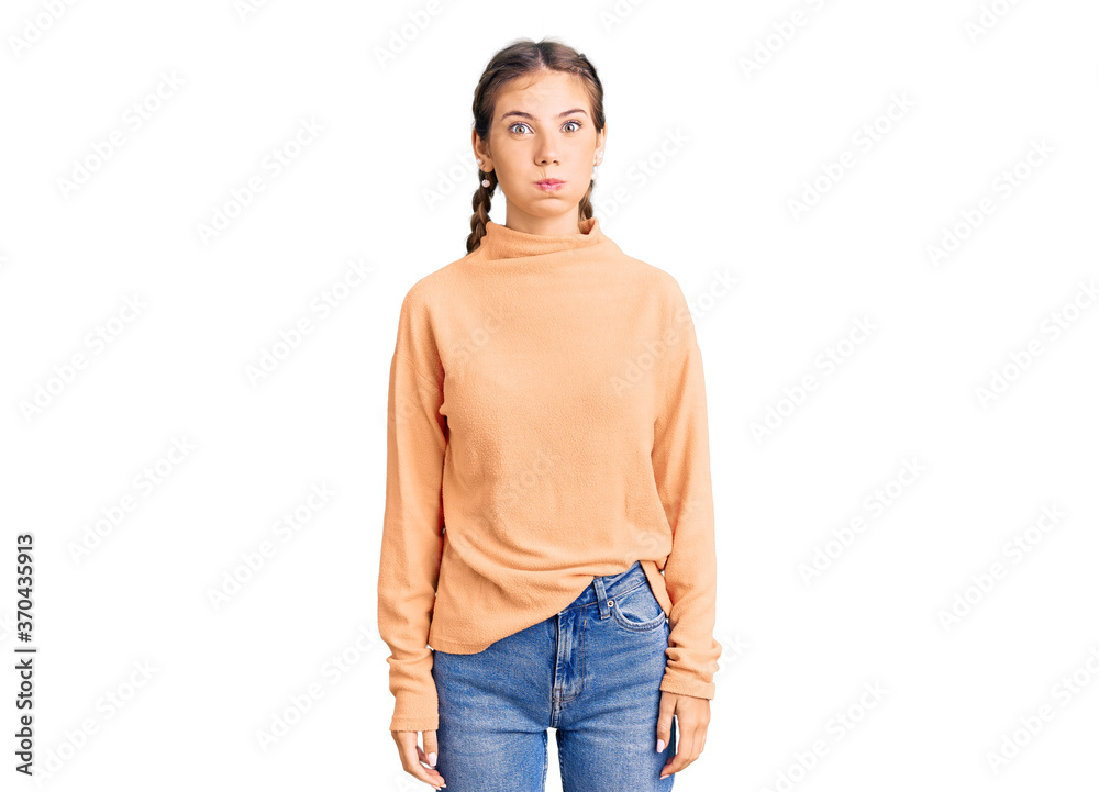 Fototapeta premium Beautiful caucasian woman with blonde hair wearing casual winter sweater puffing cheeks with funny face. mouth inflated with air, crazy expression.