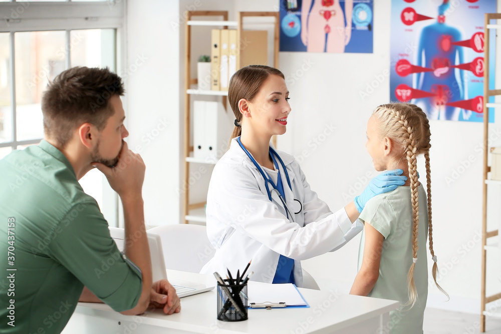 Fototapeta premium Doctor examining little girl with thyroid gland problem in clinic