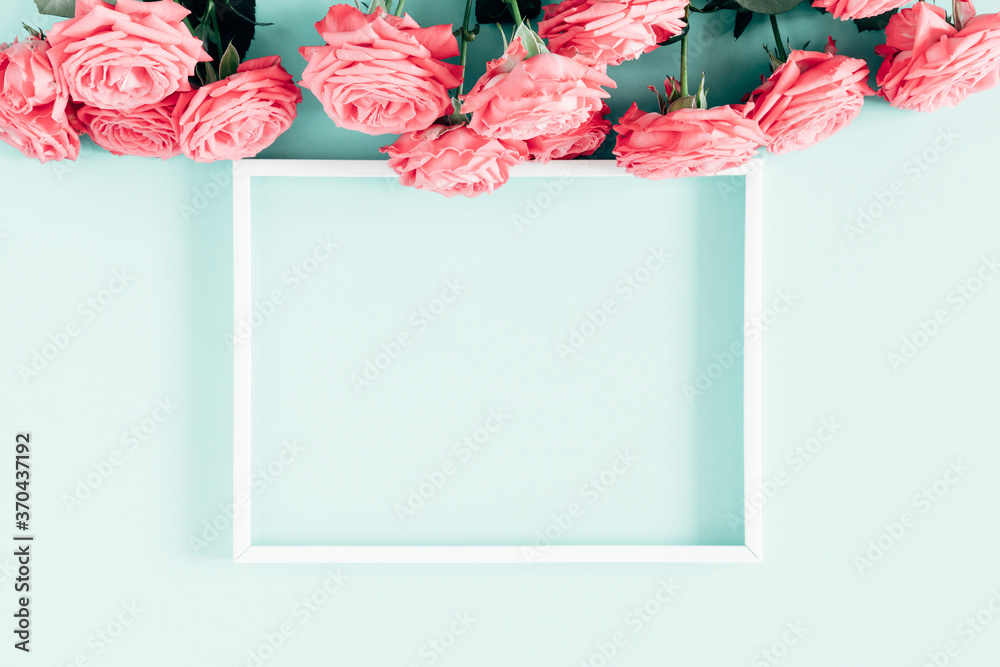 Obraz premium Beautiful flowers composition. Photo Frame, pink rose flowers on pastel blue background. Valentines Day, Womens day, Mother's day, concept, design. Flat lay, top view, copy space