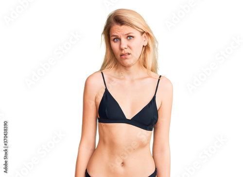 Young beautiful blonde woman wearing bikini skeptic and nervous, frowning upset because of problem. negative person. © Krakenimages.com