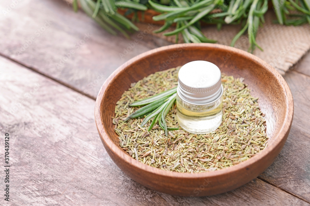 Bottle of rosemary essential oil on table Bottle of rosemary essential oil on table