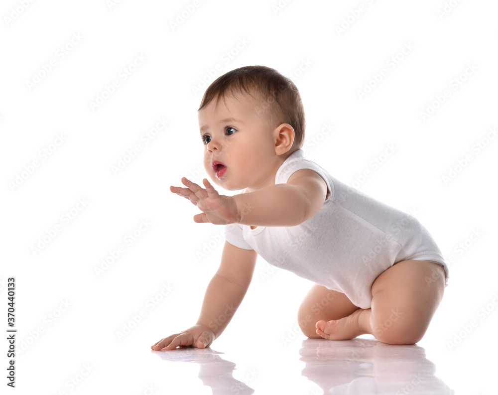 Little baby girl toddler in diaper and white blank body suit crawling on floor and looking up at the corner isolated on white Little baby girl toddler in diaper and white blank body suit crawling on floor and looking up at the corner isolated on white
