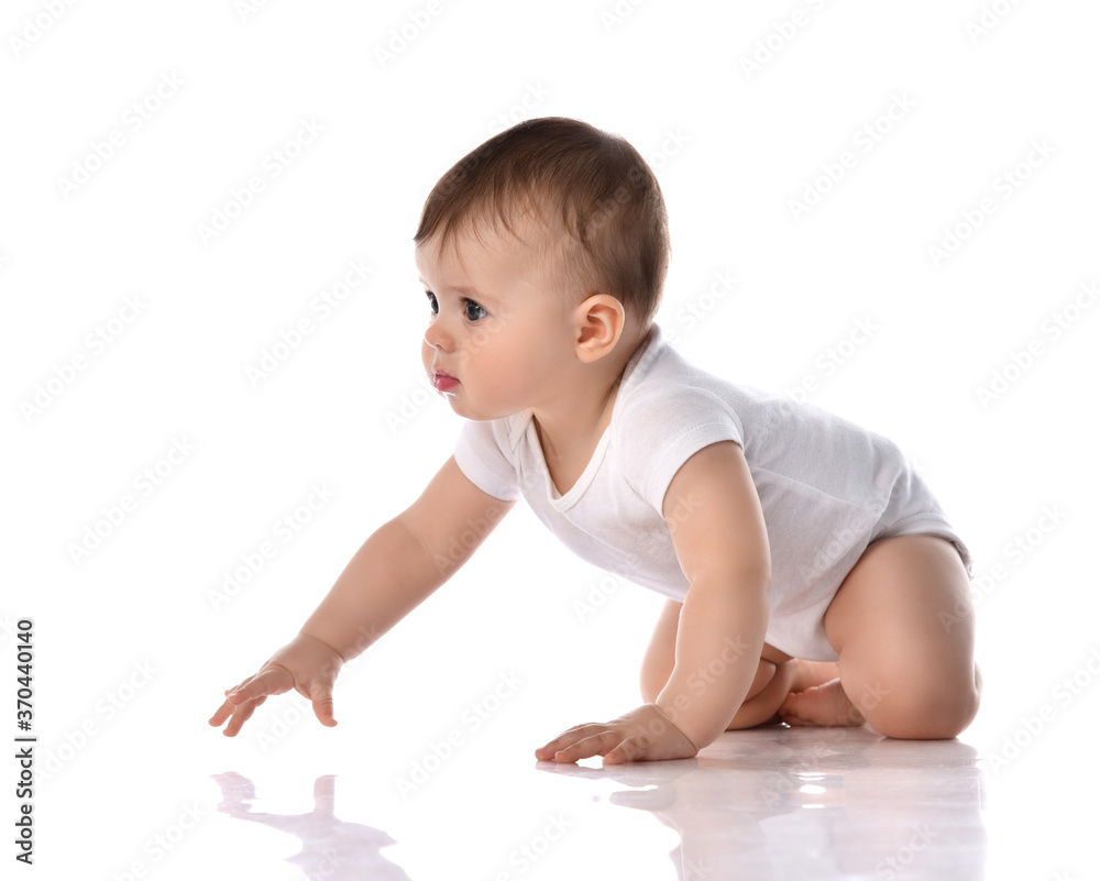 Little baby girl toddler in diaper and white blank body suit crawling on floor and looking up at the corner isolated on white Little baby girl toddler in diaper and white blank body suit crawling on floor and looking up at the corner isolated on white