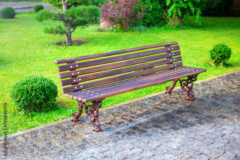 Park bench and green lawn . Nobody in the city park Park bench and green lawn . Nobody in the city park