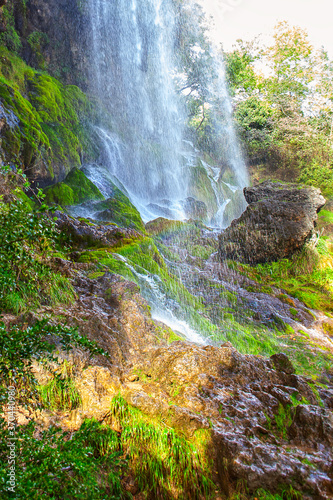 Natural waterfall in the mountain . Cascade water flows on the rock