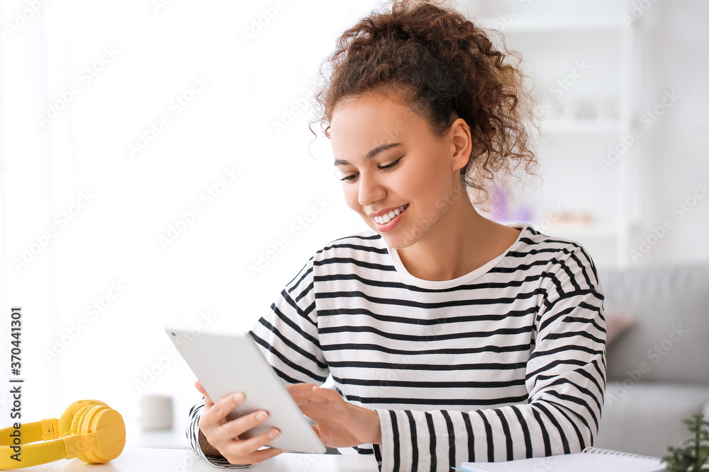 Young woman using tablet computer for online learning at home Young woman using tablet computer for online learning at home