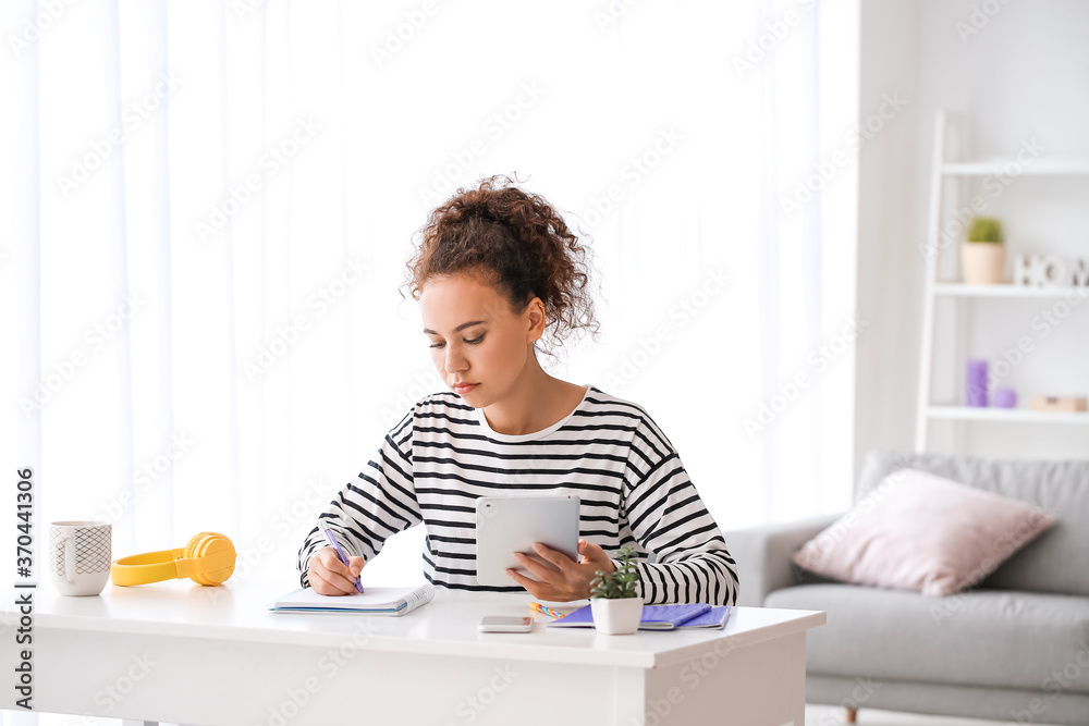 Young woman using tablet computer for online learning at home Young woman using tablet computer for online learning at home