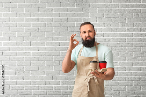 Male barista showing OK on ...