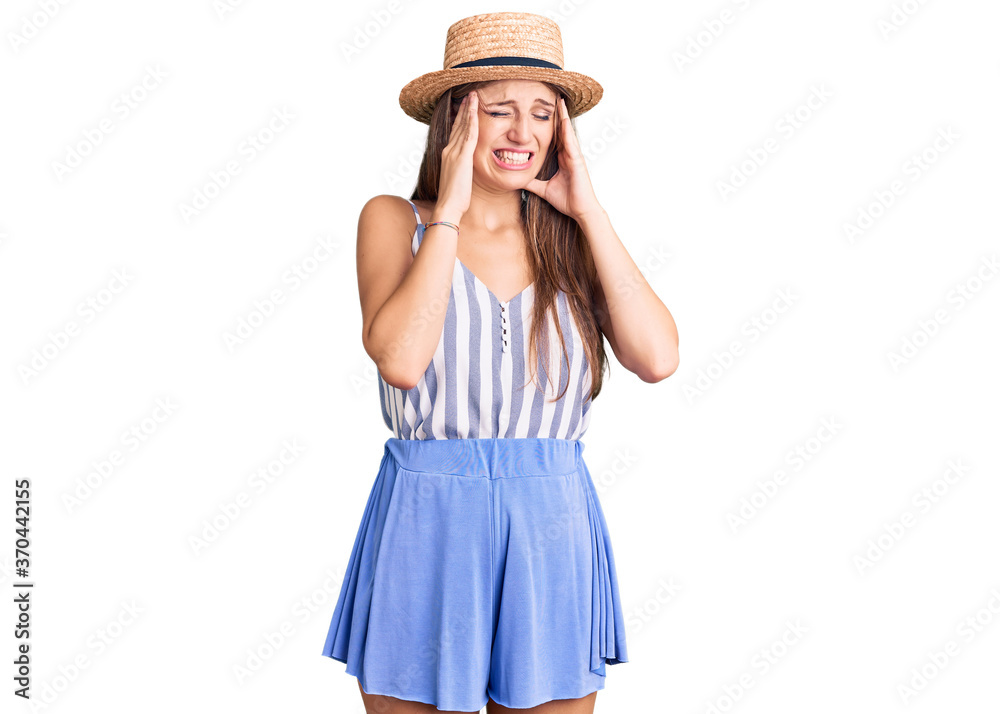 Young beautiful blonde woman wearing summer hat with hand on head, headache because stress. suffering migraine.