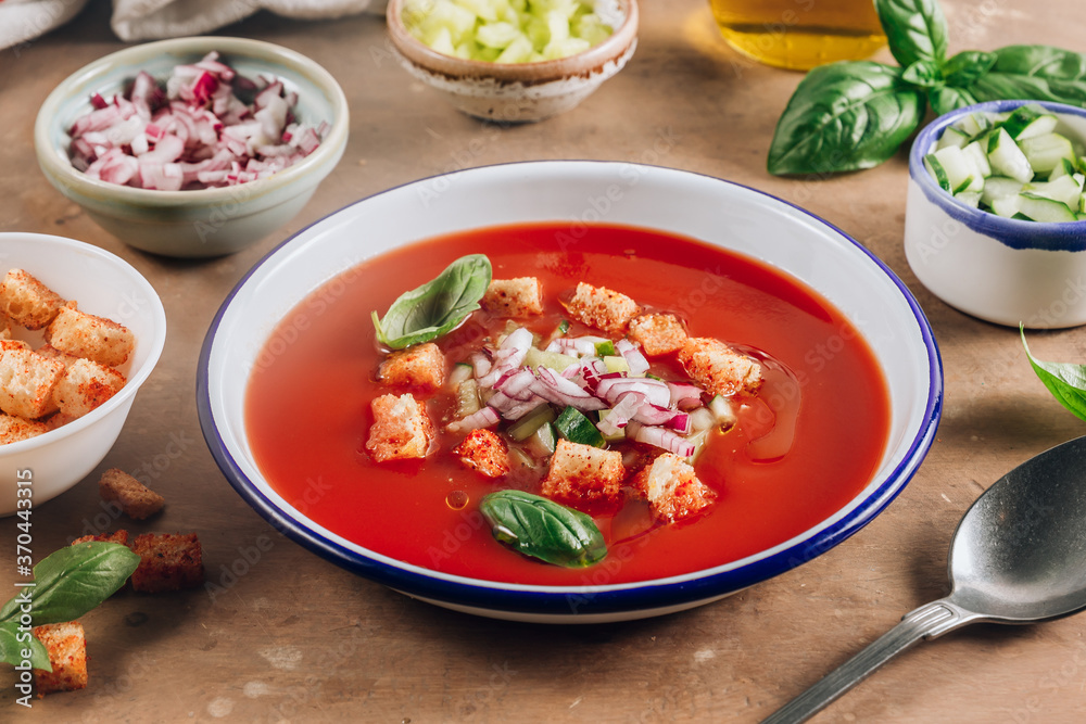 Spanish summer cold soup gazpacho with vegetables on beige rustic background.