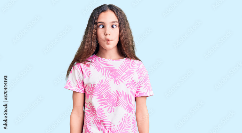 Cute hispanic child girl wearing casual clothes making fish face with lips, crazy and comical gesture. funny expression. Cute hispanic child girl wearing casual clothes making fish face with lips, crazy and comical gesture. funny expression.