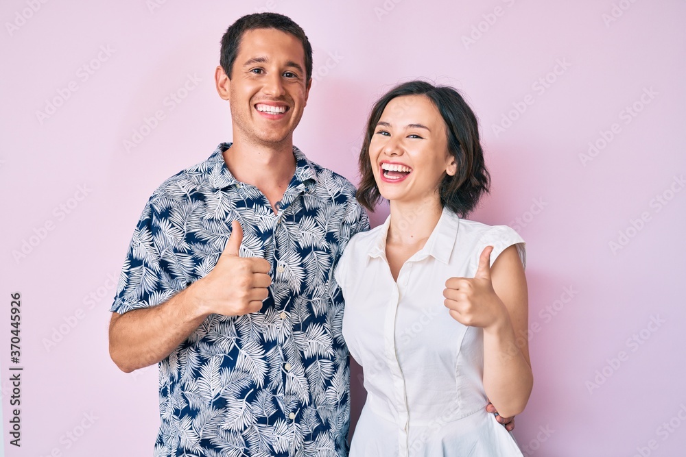 Beautiful couple wearing casual clothes success sign doing positive gesture with hand, thumbs up smiling and happy. cheerful expression and winner gesture. Beautiful couple wearing casual clothes success sign doing positive gesture with hand, thumbs up smiling and happy. cheerful expression and winner gesture.