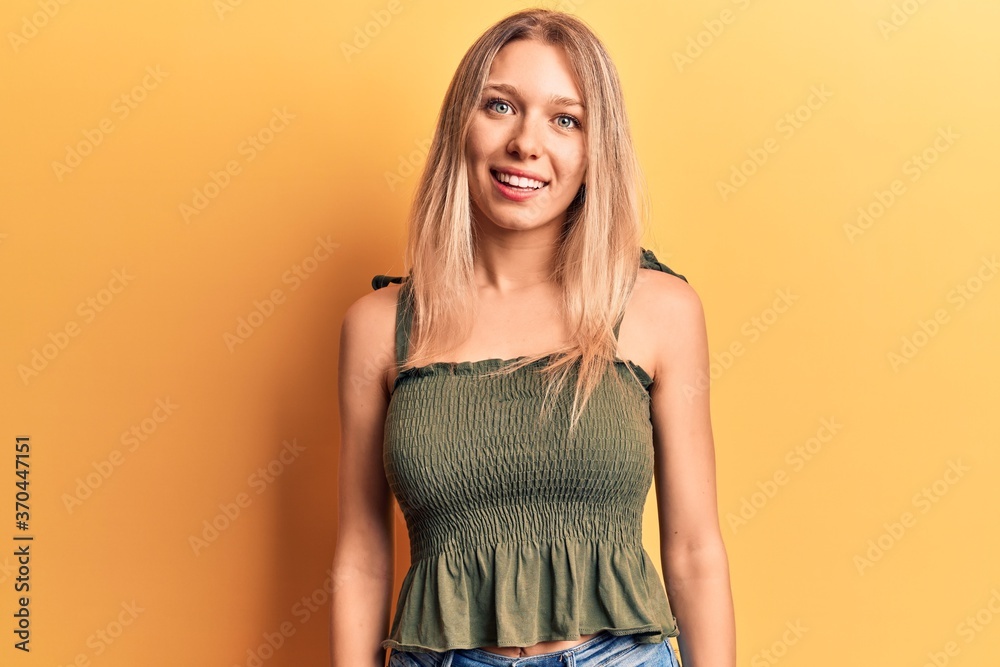 Young blonde woman wearing casual clothes with a happy and cool smile on face. lucky person. Young blonde woman wearing casual clothes with a happy and cool smile on face. lucky person.