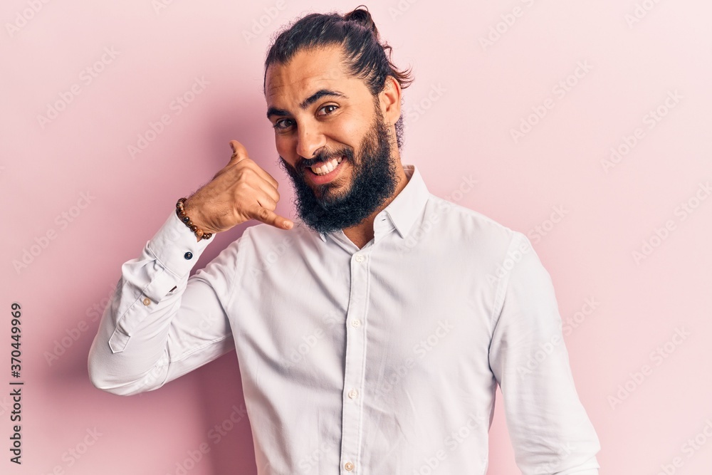 Obraz premium Young arab man wearing casual clothes smiling doing phone gesture with hand and fingers like talking on the telephone. communicating concepts.