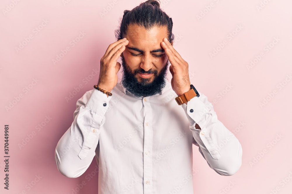 Young arab man wearing casual clothes with hand on head for pain in head because stress. suffering migraine. Young arab man wearing casual clothes with hand on head for pain in head because stress. suffering migraine.