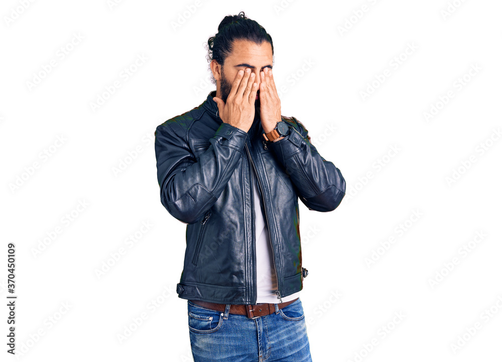 Young arab man wearing casual leather jacket rubbing eyes for fatigue and headache, sleepy and tired expression. vision problem Young arab man wearing casual leather jacket rubbing eyes for fatigue and headache, sleepy and tired expression. vision problem
