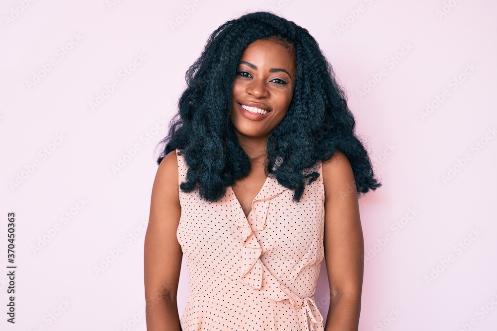 Beautiful african woman wearing casual summer clothes with a happy and cool smile on face. lucky person. Beautiful african woman wearing casual summer clothes with a happy and cool smile on face. lucky person.