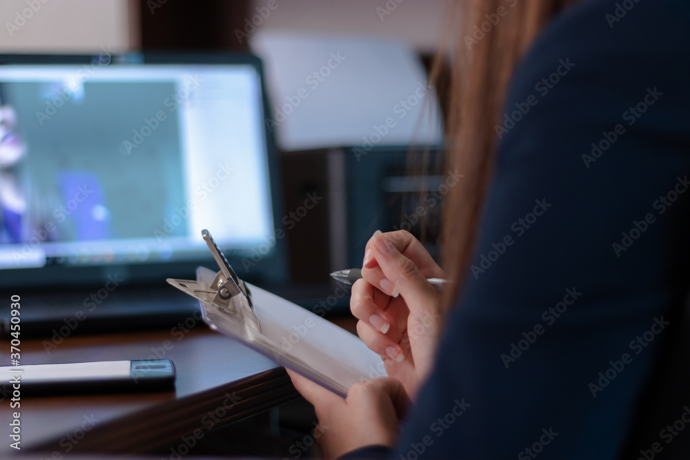 Writing notes in an online therapy with a psychologist Writing notes in an online therapy with a psychologist