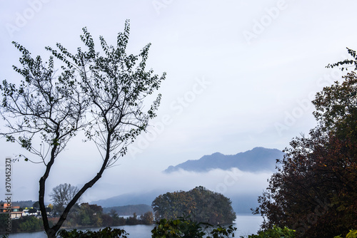 Beautiful autumn scenery  water mist over the lake and sea clouds on the mountain at dawn.