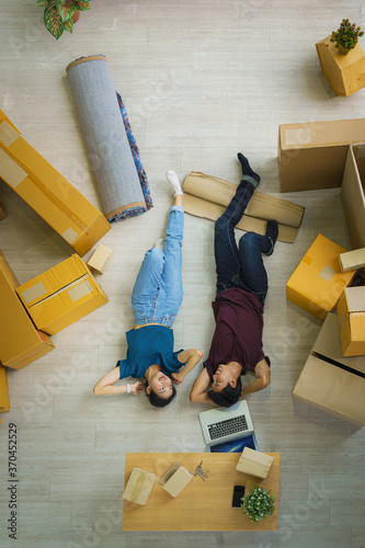 couple relax after unpacking boxes from house moving and relacation photo