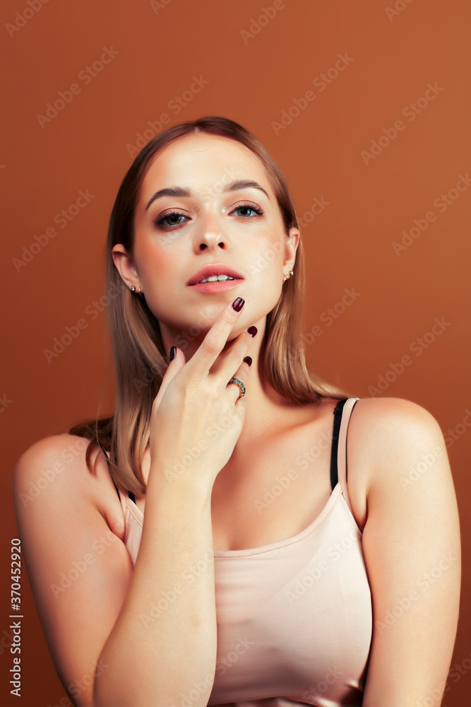 young pretty blond woman with fresh natural makeup posing cheerful on browm background, lifestyle people concept young pretty blond woman with fresh natural makeup posing cheerful on browm background, lifestyle people concept