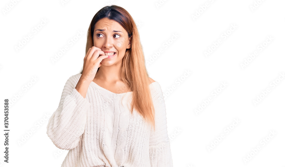 Beautiful young woman wearing casual clothes looking stressed and nervous with hands on mouth biting nails. anxiety problem. Beautiful young woman wearing casual clothes looking stressed and nervous with hands on mouth biting nails. anxiety problem.