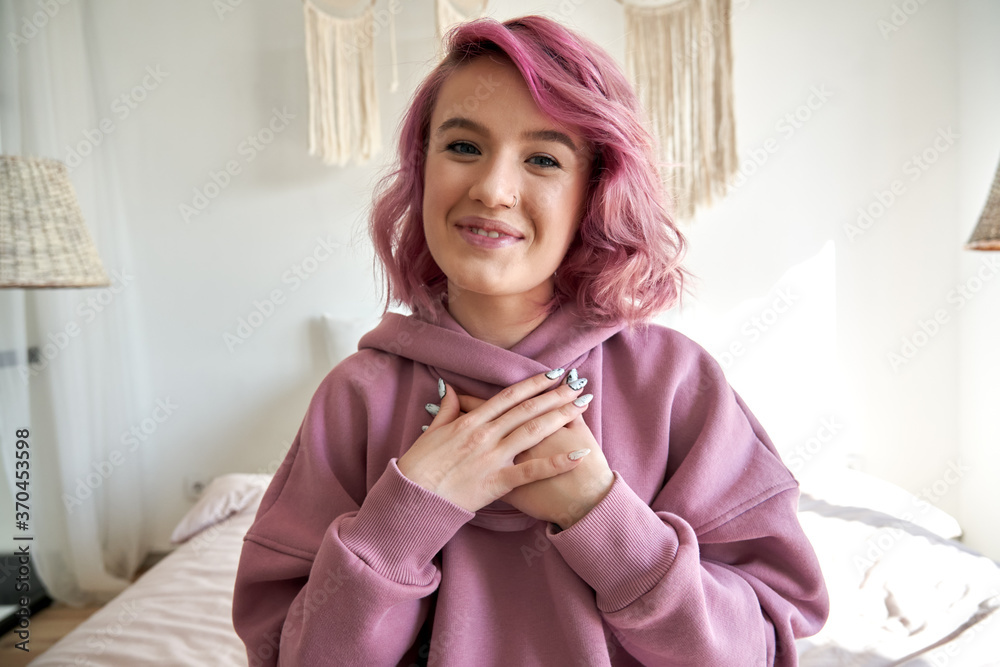 Happy hipster gen z teen girl blogger with smiling face with pink hair  looking at camera