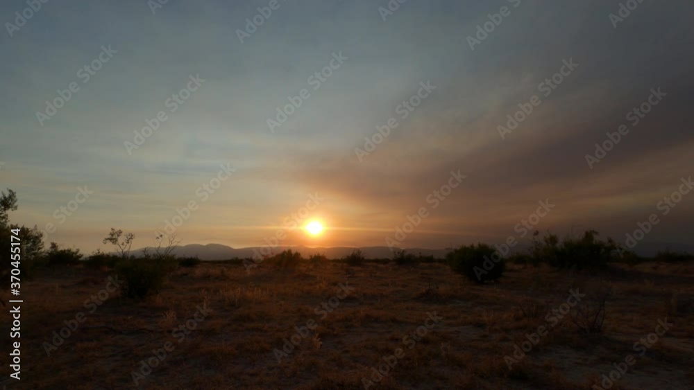 Time lapse of the sun setting on the Mojave Desert landscape with the smoke from the Stagecoach wildfire darkening the sky Time lapse of the sun setting on the Mojave Desert landscape with the smoke from the Stagecoach wildfire darkening the sky