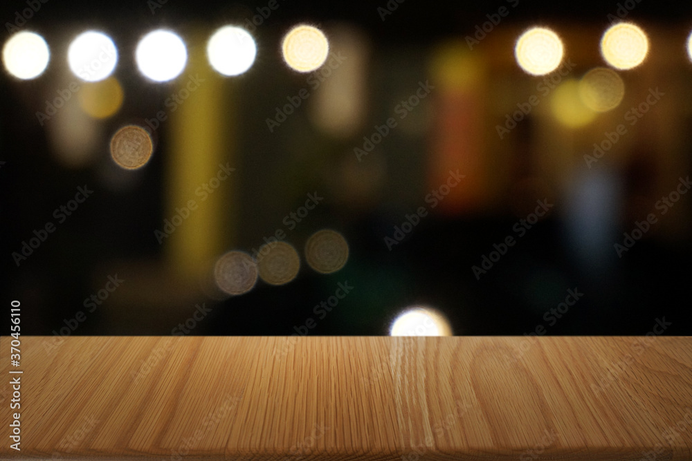 Empty dark wooden table in front of abstract blurred bokeh background of restaurant . can be used for display or montage your products.Mock up for space. Empty dark wooden table in front of abstract blurred bokeh background of restaurant . can be used for display or montage your products.Mock up for space.