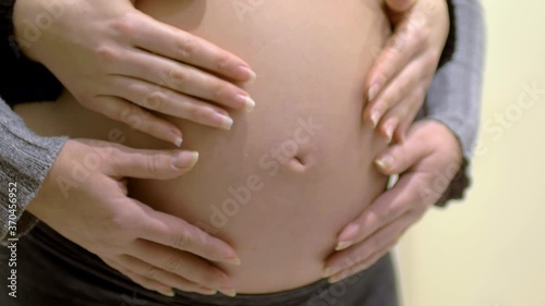 Wallpaper Mural Portrait of happy lgbt lesbian family expecting a baby. Mixed race women in love, petting a big belly. Happiness of motherhood. IVF, LGBTQI, LGBT Pride Month, relationship, childbirth concept. Torontodigital.ca