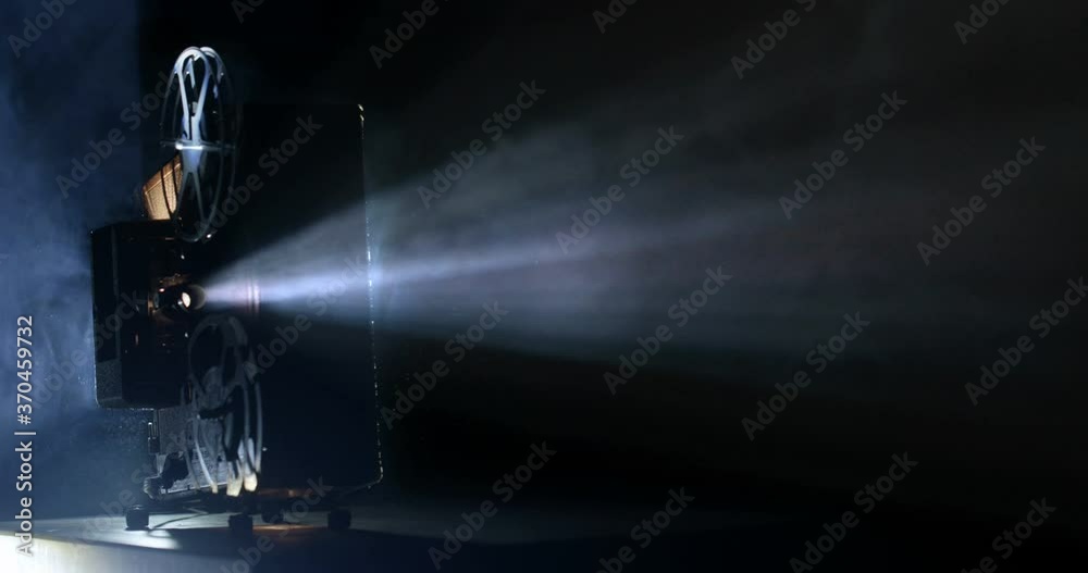 Vintage antique film projector with beam shot in 4K resolution at 60fps