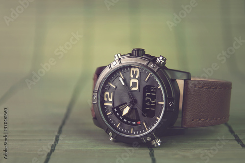 Men's wrist watch on wooden background