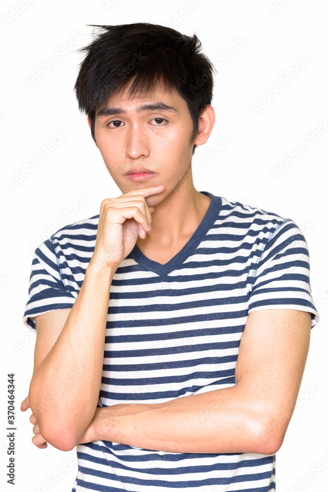 Portrait of young handsome Asian man thinking Portrait of young handsome Asian man thinking