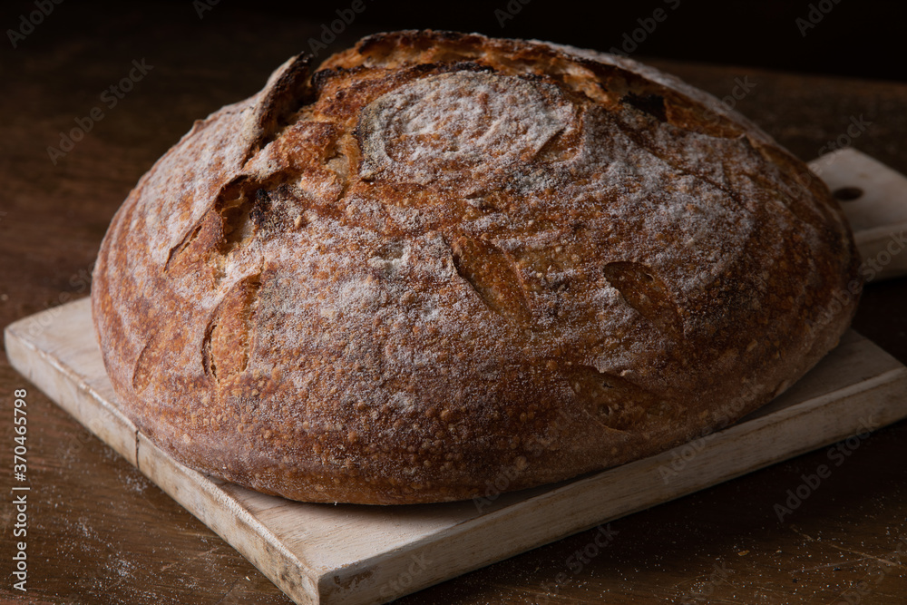 Freshly baked sourdough bread with floral decoration on it 