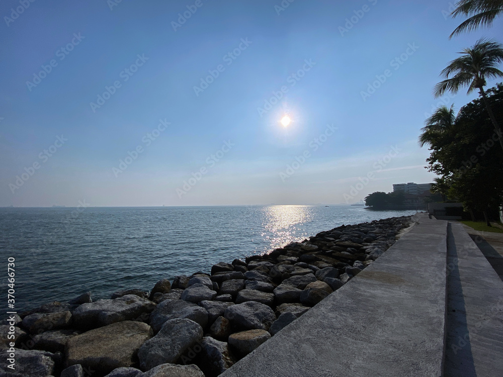 morning sunrise sea blue sky calm wave rocky shore Penang Malaysia