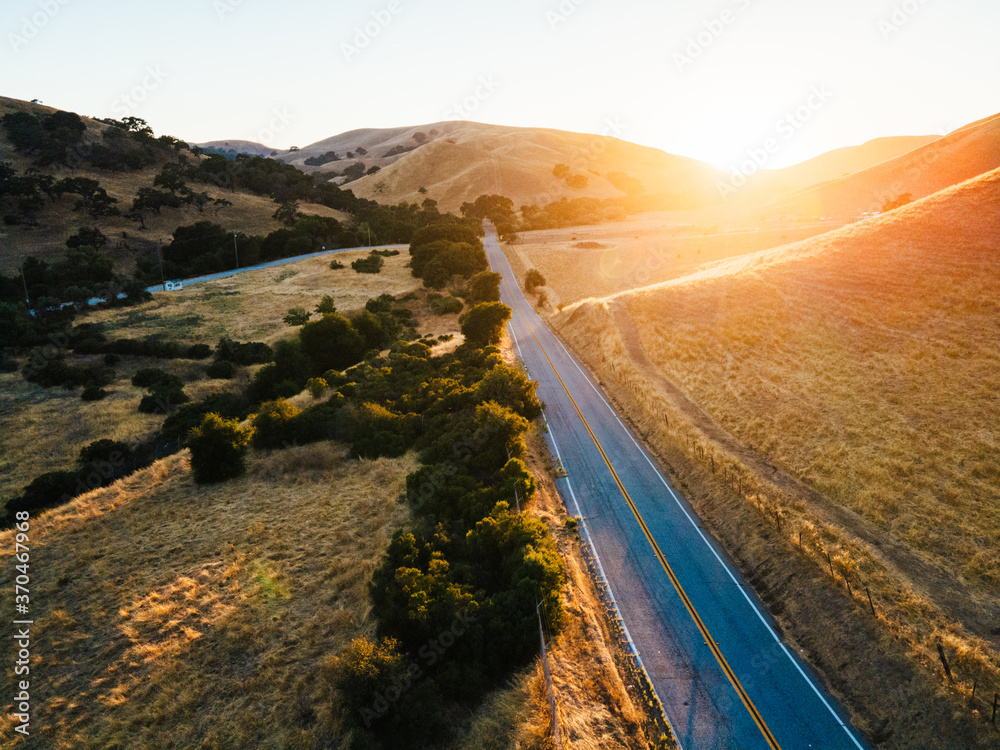 Drone aerial photo Straight country road during sunrise or sunset 