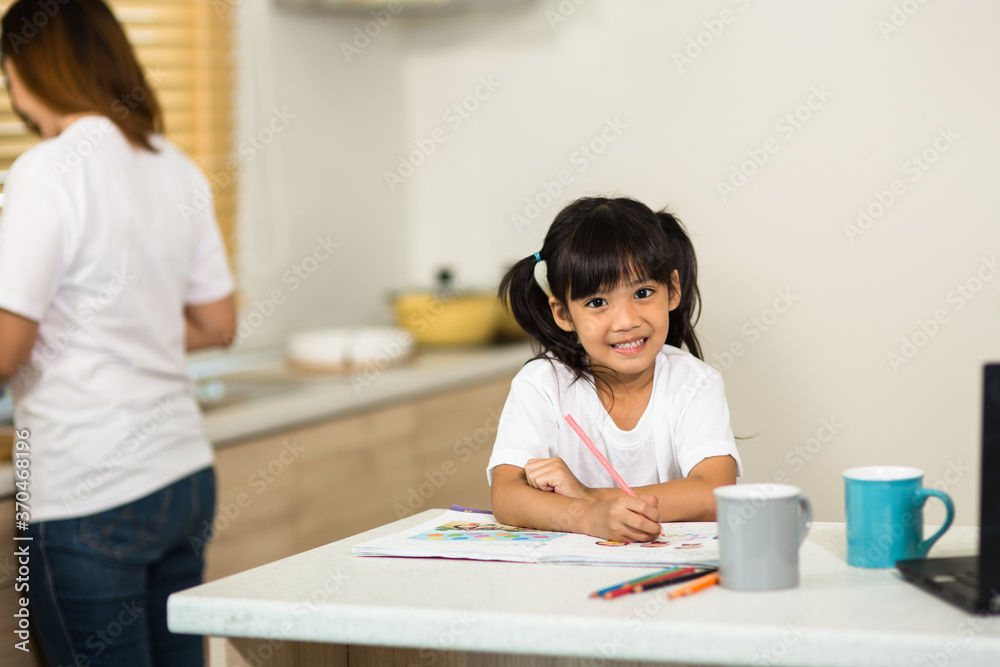 Coronavirus Outbreak. Lockdown and school closures. Schoolgirl watching online education class, happy talking with teacher on the internet at home. COVID-19 pandemic forces children online learning