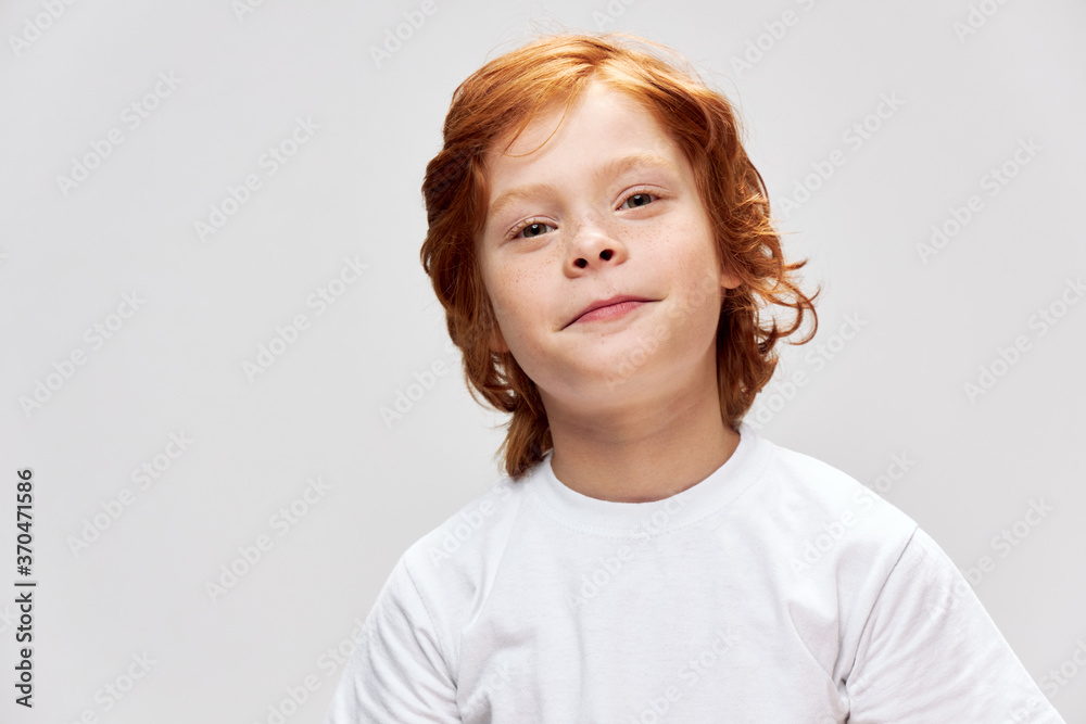 Portrait of a red-haired boy in a white t-shirt close-up smile Portrait of a red-haired boy in a white t-shirt close-up smile