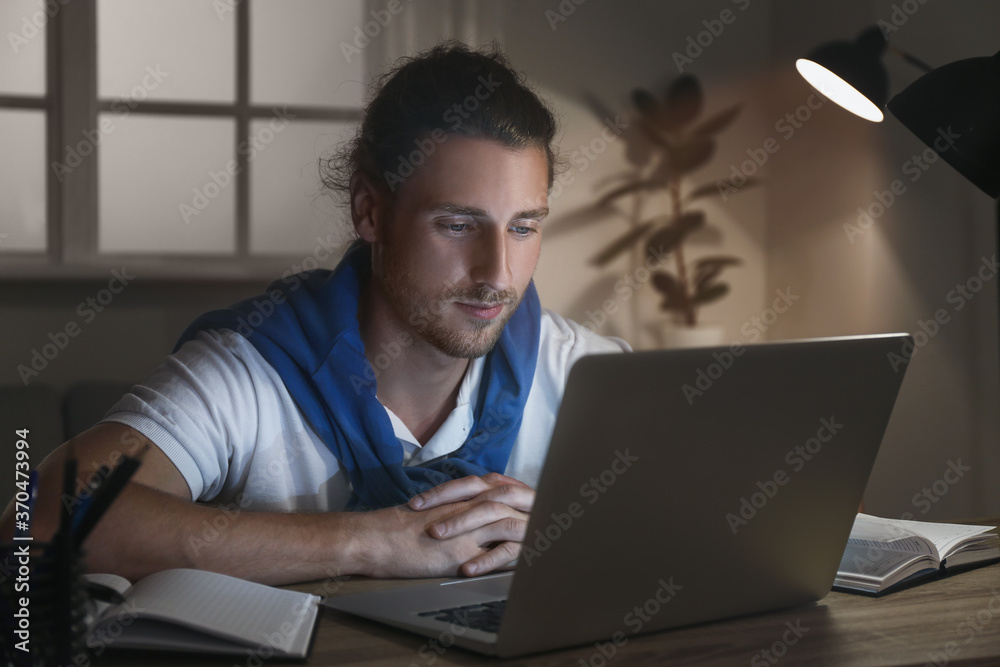 Young man using laptop for online learning at home Young man using laptop for online learning at home