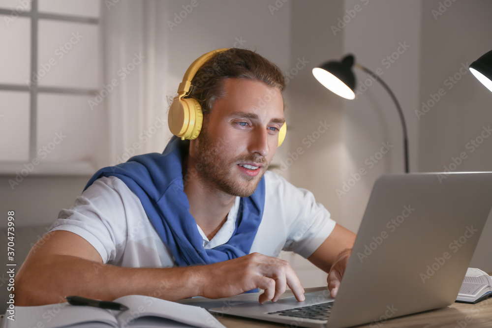 Young man using laptop for online learning at home Young man using laptop for online learning at home
