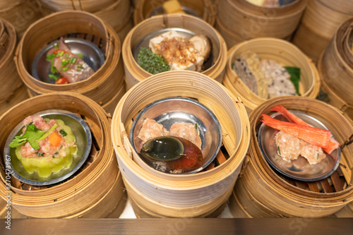 Variety of dim sum in bamboo basket. Chinese breakfast style in Southern of Thailand.