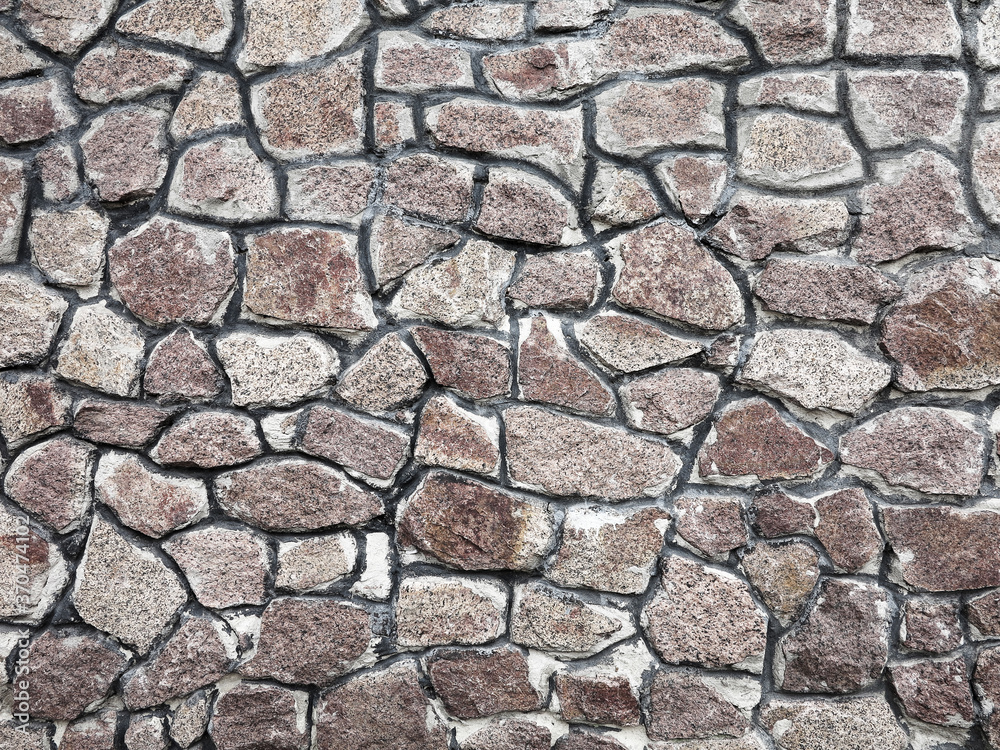 Stone wall background. Background of stone wall of boulders and pebbles Stone wall background. Background of stone wall of boulders and pebbles